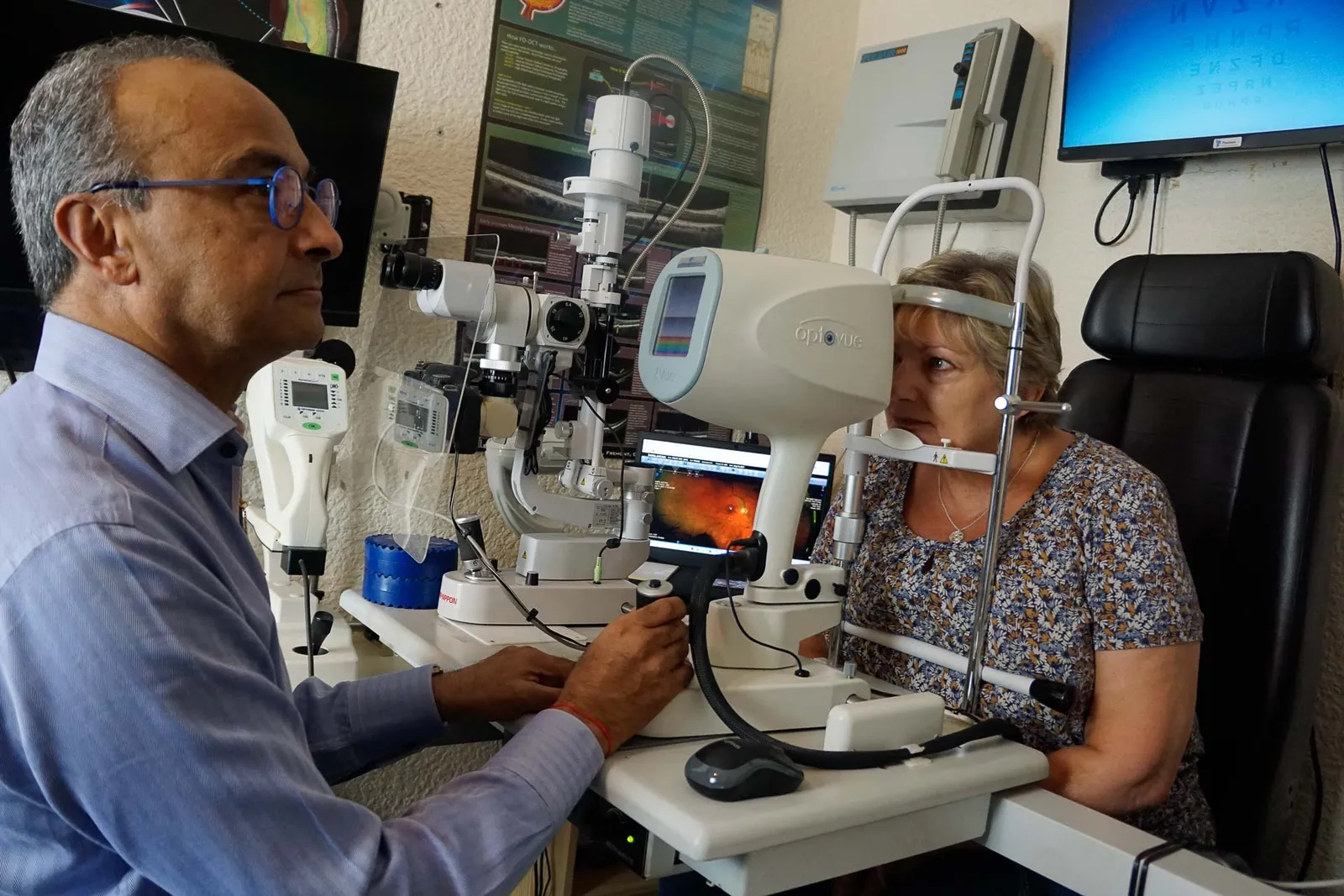 An optometrist checking a patient’s eyes with the slit lamp in the Nu-Sight consulting room