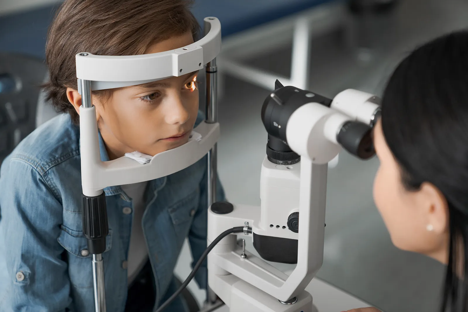 A boy on the chin rest of an eye scanner