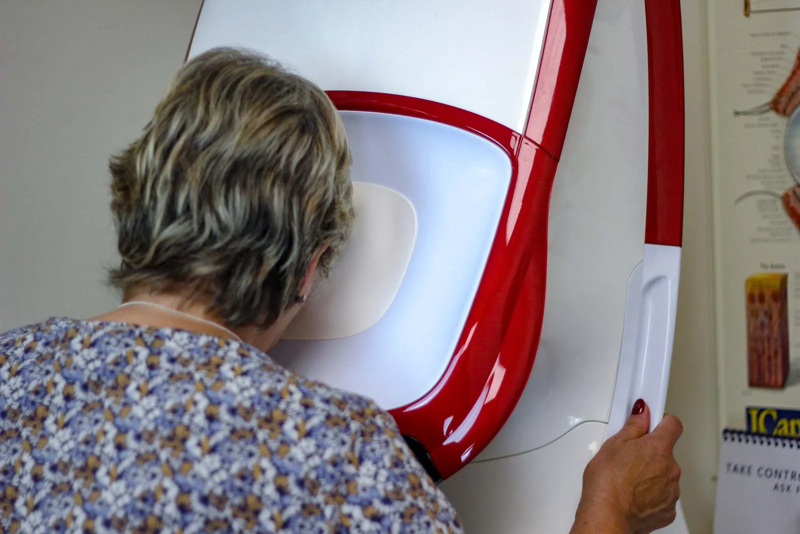 A patient looking into the Optomap retinal scanner at Nu-Sight Opticians