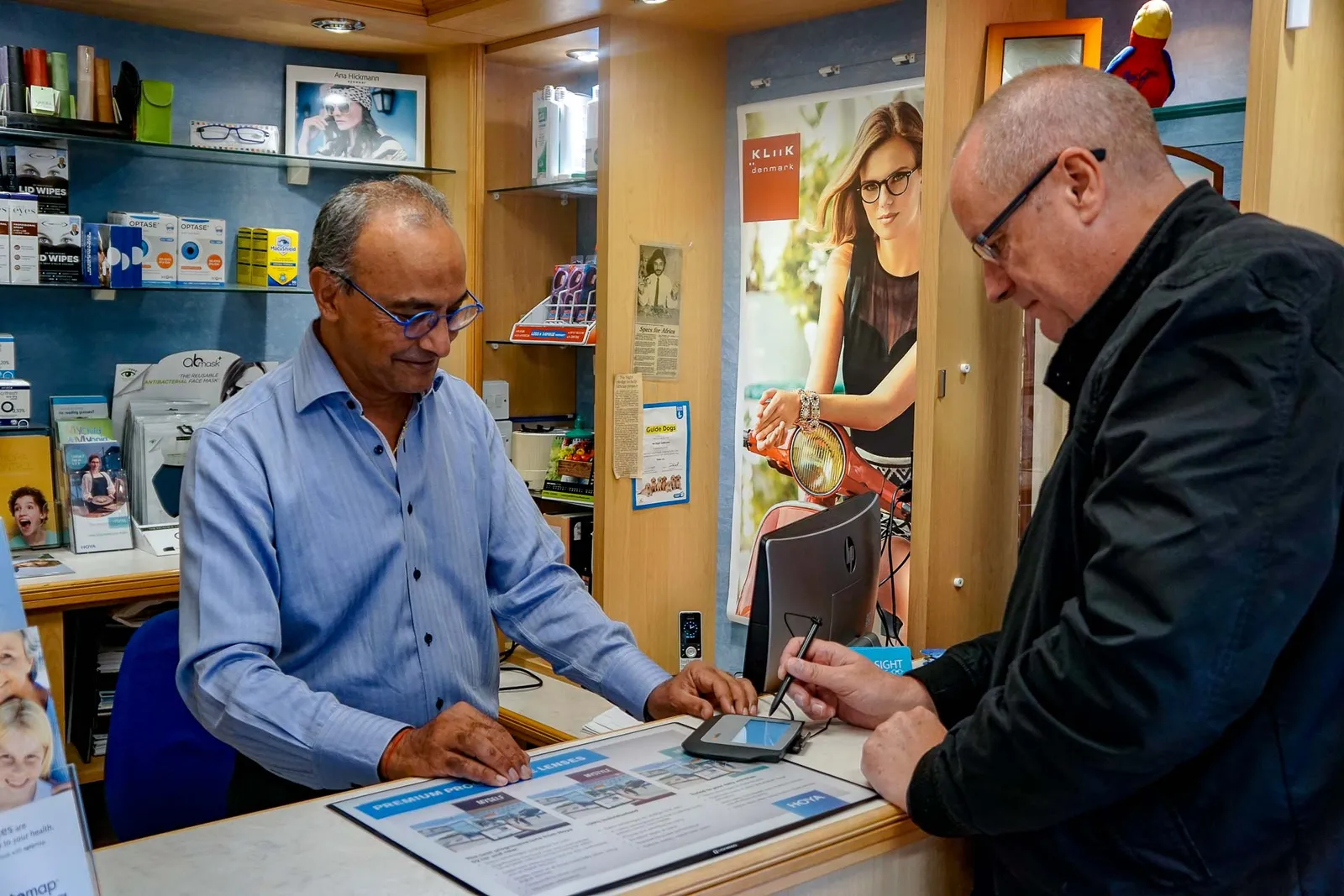A patient and optometrist talking at the Nu-Sight dispensing desk